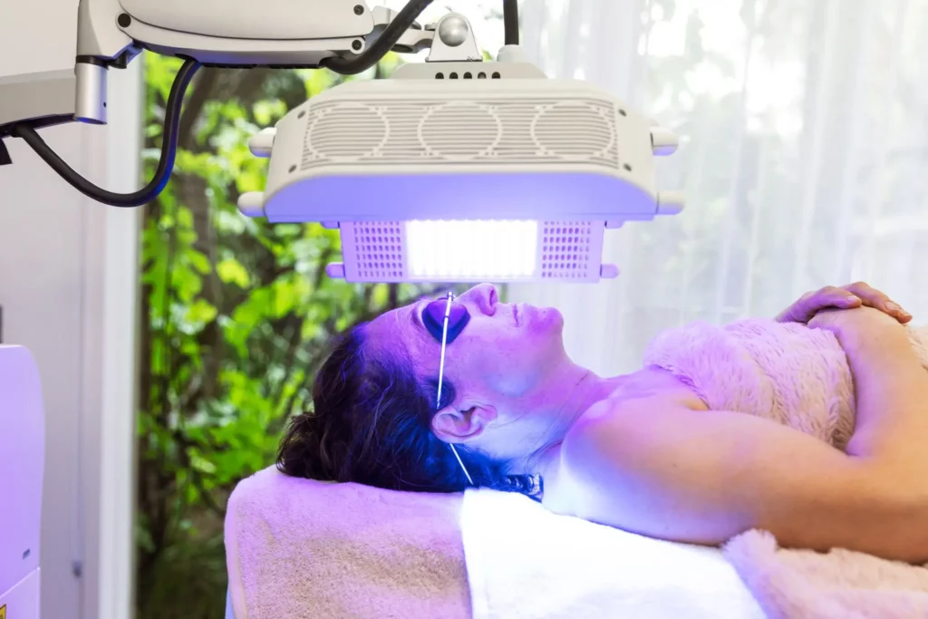 LED facials with blue light therapy. Lady lying on treatment bed